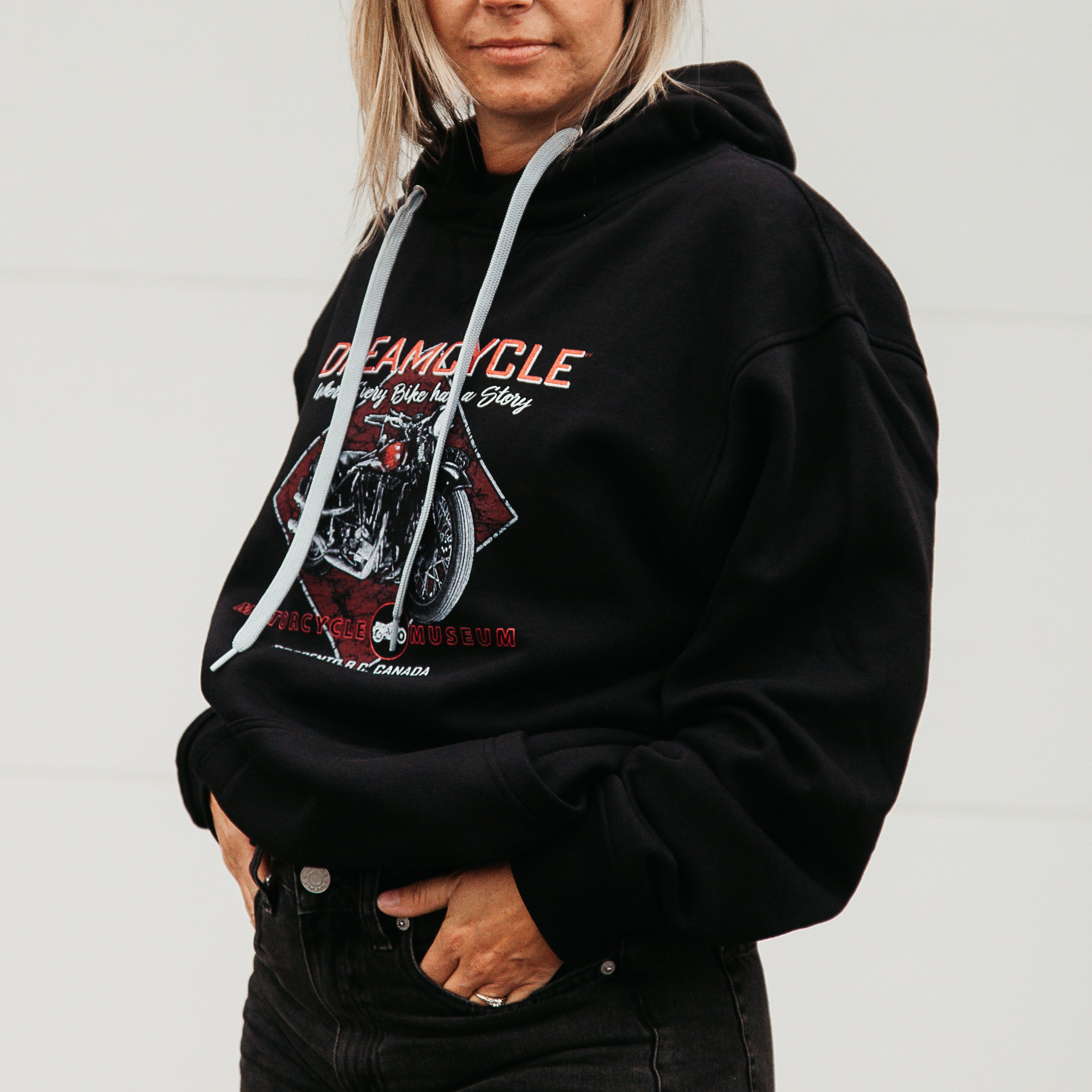  Dreamcycle Motorcycle Museum |  Female modeling black dreamcycle hoodie in a lifestyle environment.