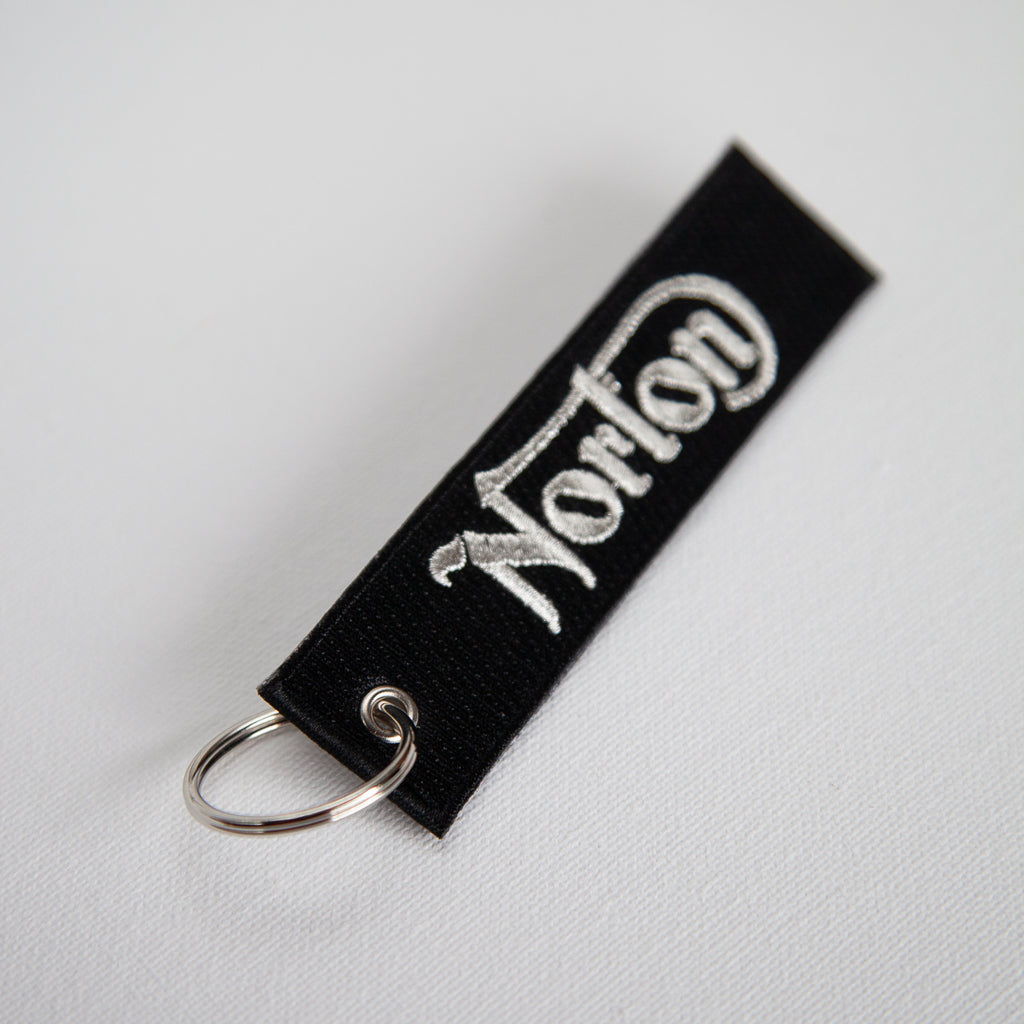 Dreamcycle Motorcycle Museum |  Norton Black keychain on white background. 