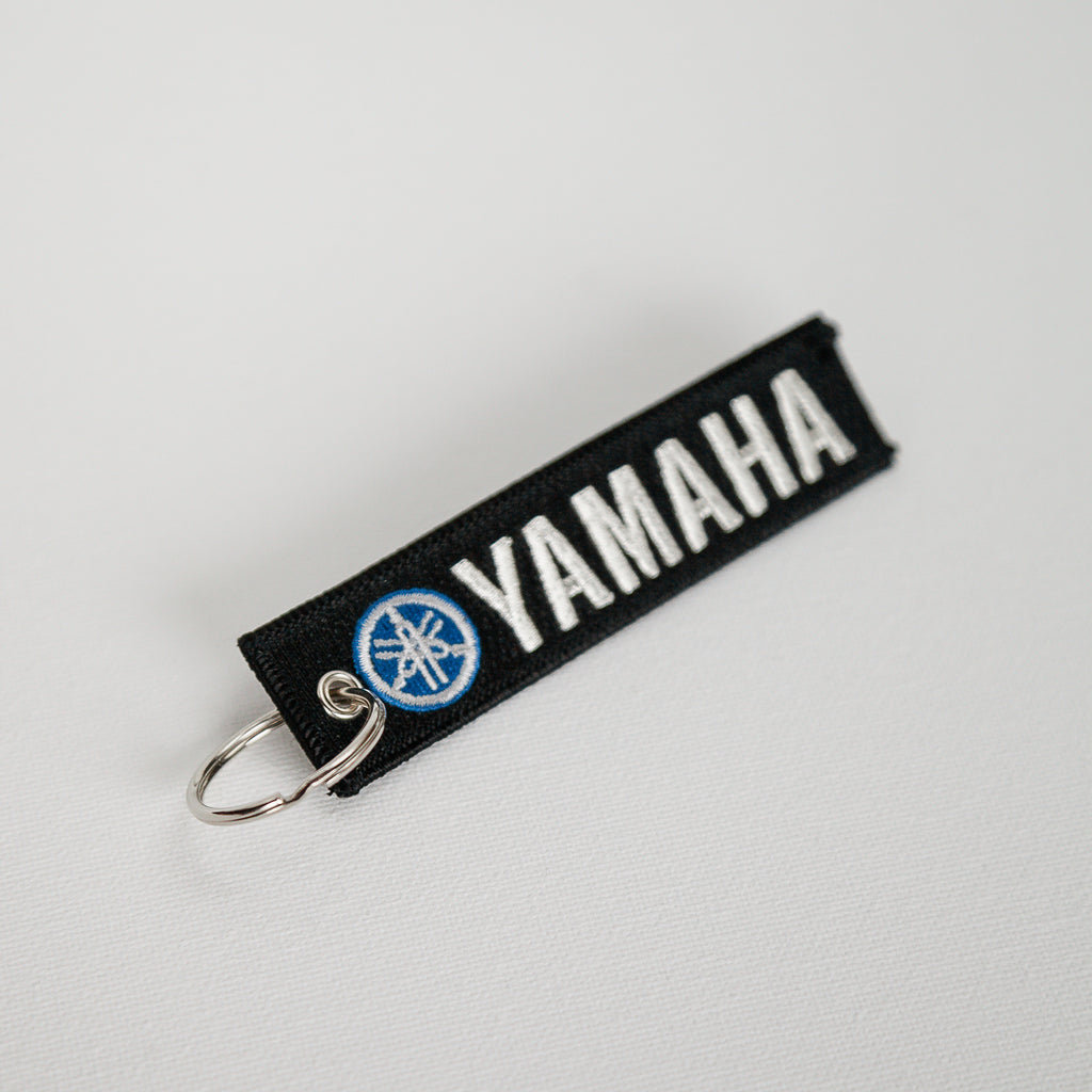 Dreamcycle Motorcycle Museum |  Yamaha keychain on white background.\